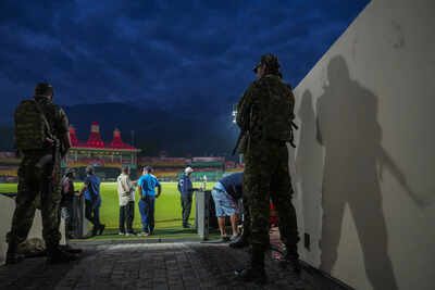 Dharamsala security personnel stand guard amid a practice session ahead of an i .jpg