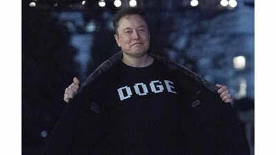 Elon musk wearing a t shirt that reads doge.jpg