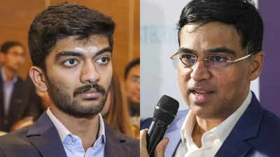 D gukesh and viswanathan anand photos by pti.jpg