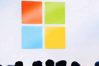 File a microsoft logo is seen on a screen as people listen at an event at microsoft headquarters may.jpeg
