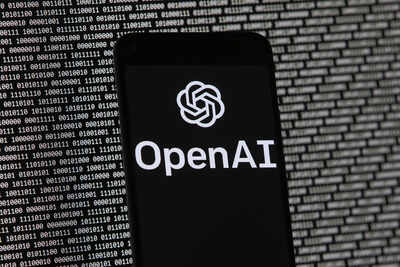 File the openai logo appears on a mobile phone in front of a computer screen with random binary data.jpeg