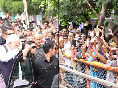 Gujarat pm modi responds to a child with a salute during bhavnagar roadshow.jpg