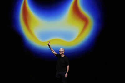 Apple ceo tim cook waves on stage during an announceament of new products at apple park on tuesday s.jpeg