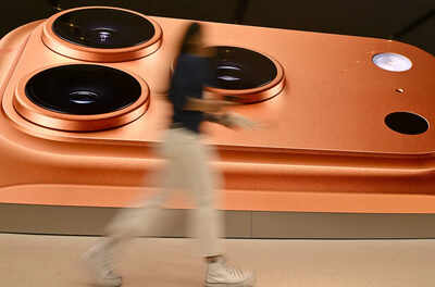 Sydney australia september 19 a consumer passes in front of a billboard displaying apple39s newly la.jpeg