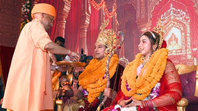 Uttar pradesh chief minister yogi adityanath applies tilak on the forehead of artists dressed up as.png