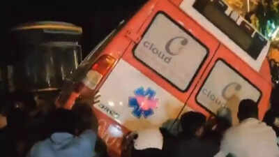 Angry crowd flips ambulance which had no occupant or patient.jpg