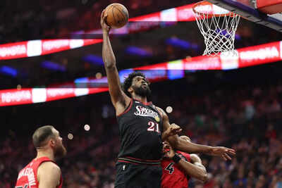 Philadelphia 76ers center joel embiid 21 drives for a shot against toronto raptors forward scottie b.jpeg