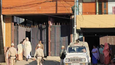 Police personnel outside the home of the retired police officer in imphal on friday.jpg