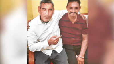 Rikhi ram r with a relative during his reunion visit to his village.jpg
