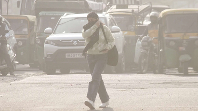 A woman covers her face with a scarf amid rising pollution levels.jpg