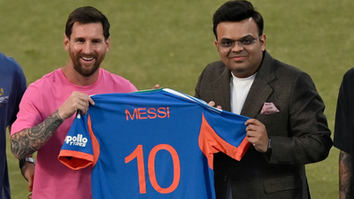 Jay shah presents lionel messi with a jersey.jpg