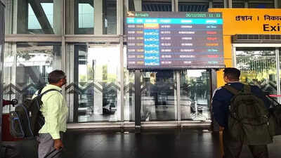 Passengers check flight information board at kolkata airport.jpg
