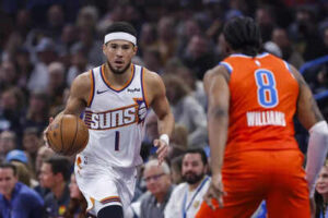 Phoenix suns guard devin booker 1 dribbles down the court against the oklahoma city thunder.jpg