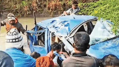 Villagers try to bring out the passengers from the mangled car.jpg