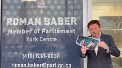 Canada mp roman baber joins iran protest trend as he lights cigar with khameneis burning photo.jpg
