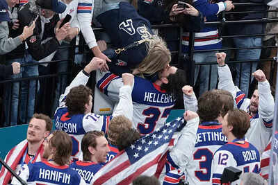 Nhl gold medalist goaltender connor hellebuyck 37 of united states celebrates with his wife andrea h.jpeg