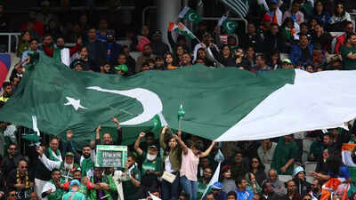 Pakistani fans holding a large flag cheer during the match photo by ap.jpg