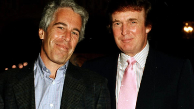 Trump with epstein file photo.jpg
