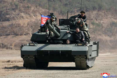 Teen daughter of north korean leader kim drives a tank while observing drill with her father.jpg